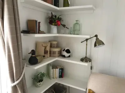 a room with white shelves with books and a lamp at Wee Dipper Cottage Maybole in Maybole