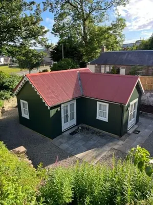a small green house with a red roof at Wee Dipper Cottage Maybole in Maybole