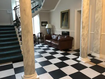 a living room with a couch and a checkered floor at Private Guest Suite in Georgian Townhouse in City Centre in Edinburgh