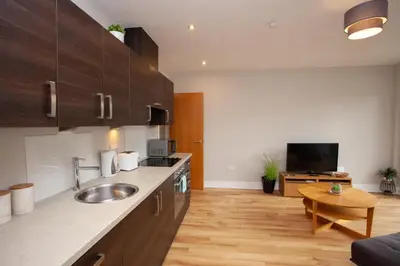 a kitchen with a sink and a counter top at 1 Bedroom Flat in the Heart of Merchant City in Glasgow