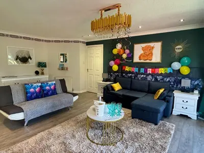 a living room with a couch and a table and balloons at FINN VILLAGE 