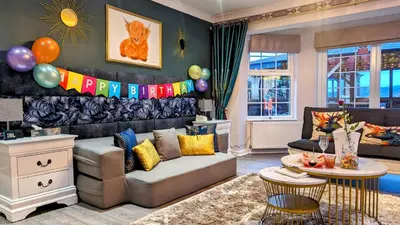 a living room with a couch and balloons on the wall at FINN VILLAGE 