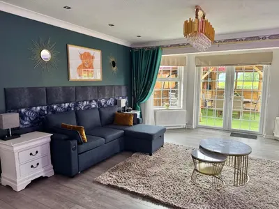 a living room with a blue couch and a table at FINN VILLAGE 