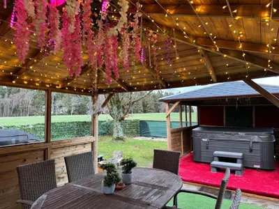 a patio with a grill under a wooden pergola at FINN VILLAGE 