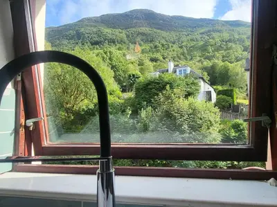 a window with a view of a mountain at Kinlochleven Holiday Home in Kinlochleven
