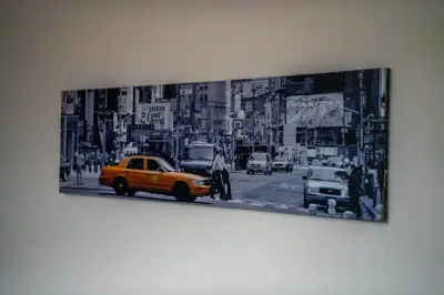 a black and white picture of a city street with a taxi at Livi House in Livingston