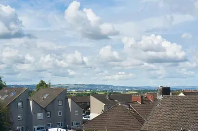 a view of roofs of houses in a town at Woodside Apartment in Coatbridge