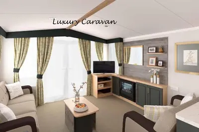 a living room with a couch and a tv at Inverbeg Holiday Park in Luss