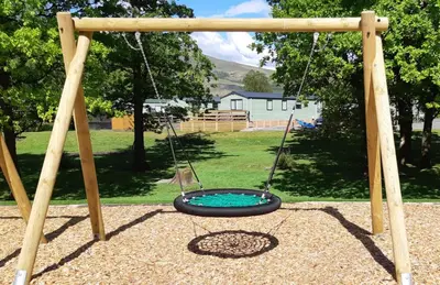 a tire swing in a playground at Inverbeg Holiday Park in Luss