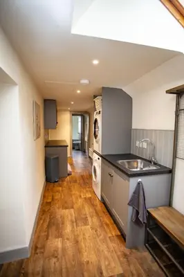 a kitchen with a sink and a dishwasher at Kennels Cottage in Killin