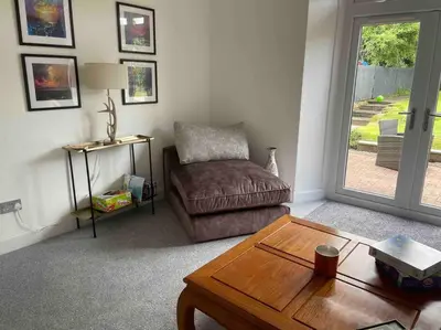 a living room with a couch and a coffee table at Fantastic home in Brightons, Falkirk. in Polmont