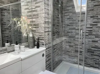 a bathroom with a shower and a sink and a tub at Fantastic home in Brightons, Falkirk. in Polmont