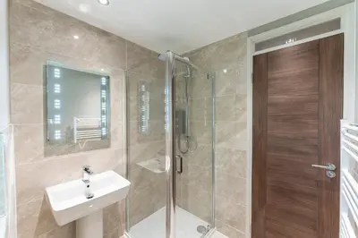 a bathroom with a shower and a sink and a shower stall at 33 Dunbar Court Gleneagles Village in Auchterarder