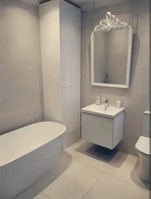 a white bathroom with a tub and a sink at One The Mews in Glasgow