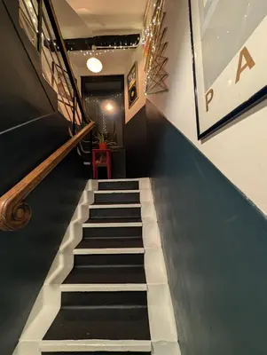 a stairway with black and white steps and a stair case at One The Mews in Glasgow