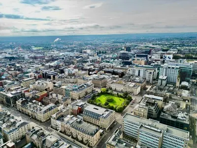 an aerial view of a city with buildings at One The Mews in Glasgow