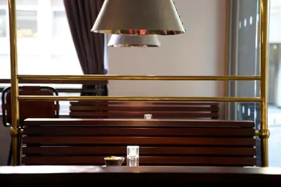 a lamp sitting on top of a wooden bench at The Z Hotel Glasgow in Glasgow