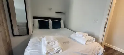 a bedroom with a bed with towels on it at The Arches The Wee Yin in Stirling