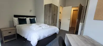 a bedroom with a bed with towels on it at The Arches The Wee Yin in Stirling