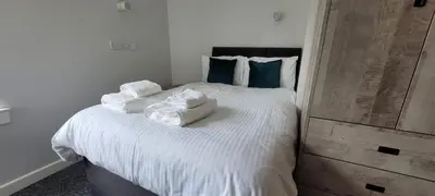 a bedroom with a bed with towels on it at The Arches The Wee Yin in Stirling