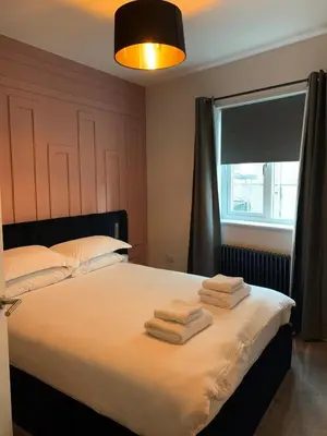 a bedroom with a bed with towels on it at Hillview in Oban