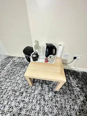 a small table with glasses on it on a floor at Rangers GuestHouse in Glasgow