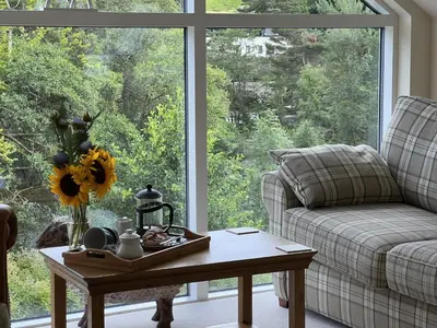 a living room with a couch and a coffee table at Tigh Muileann in Killin