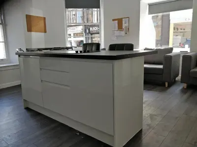 a kitchen island with a black counter top in a room at The Arches - The Big Yin in Stirling