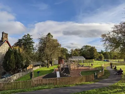 a playground in a park with at Heather Cottage Luss in Luss