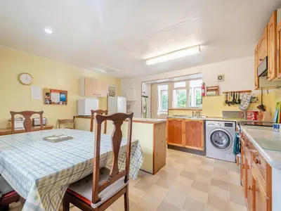 a kitchen with a table and a dining room at Brondeg Lodge in Crarae