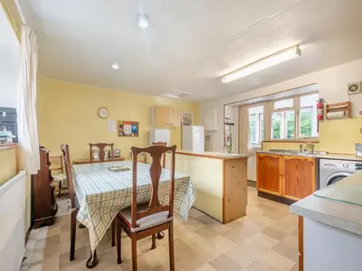 a kitchen with a table and a table and chairs at Brondeg Lodge in Crarae
