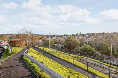 a path in a field with a fence at Super Prime Train Station Inverkeithing by TBA in Inverkeithing