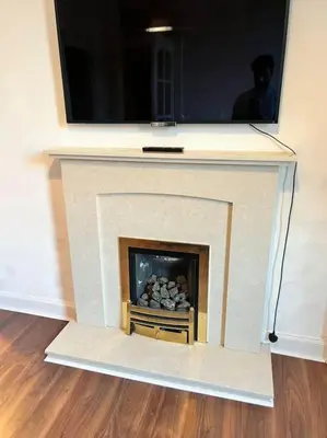 a living room with a fireplace with a tv above it at Royal Apartments Edinburgh in Edinburgh