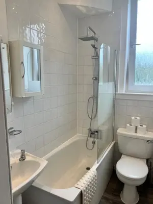 a bathroom with a tub and a toilet and a sink at Royal Apartments Edinburgh in Edinburgh