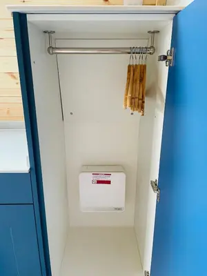 a walk in pantry with a washer and dryer at Beach House Pods in Dunoon