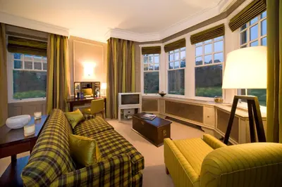 a living room with two couches and a tv at Isle of Eriska Hotel Spa & Island in Benderloch
