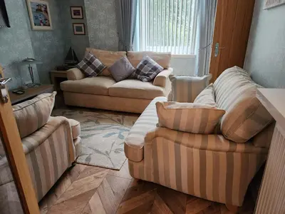 a living room with two couches and two chairs at Apartment - Largs - Sleeps 4 - Pet Friendly in Largs