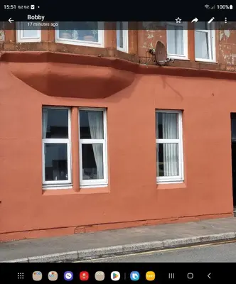 an orange building with three windows on a street at Apartment - Largs - Sleeps 4 - Pet Friendly in Largs