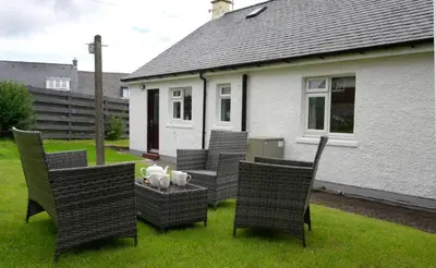 a group of chairs and a table in a yard at Ardview Cottage in Oban