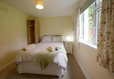 a bedroom with a bed with two towels on it at Ardview Cottage in Oban