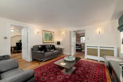 a living room with a couch and a table at Castle Gogar Cottage in Edinburgh