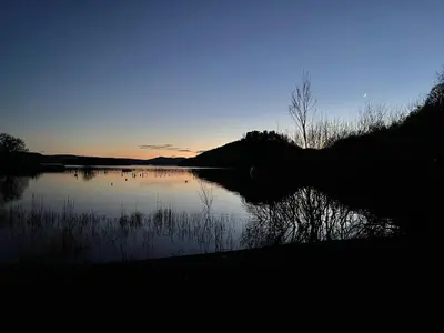 a view of a lake at sunset at Pheasant lodge - Balmaha 3 bed in Glasgow