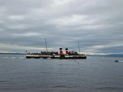 a group of people on a boat in the water at Lido Bay Ground Floor Apartment in Largs