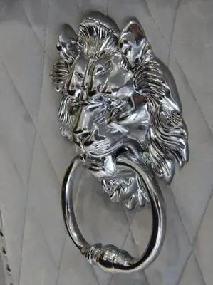 a silver statue of a lion on the floor at Modern 3BHK near Edinburgh zoo in Edinburgh