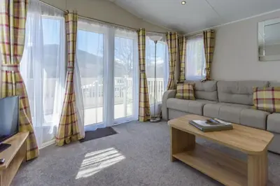a living room with a couch and a table at Heart of Glencoe Holidays in Glencoe