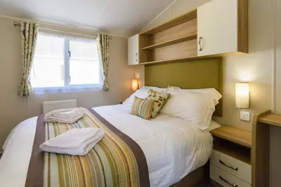 a small bedroom with a bed and a window at Heart of Glencoe Holidays in Glencoe