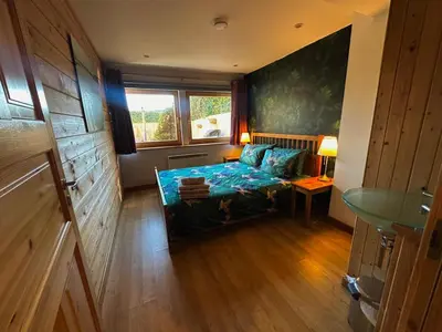 a small room with a bed and a window at Annexe Lodge cottage in Drymen in Drymen