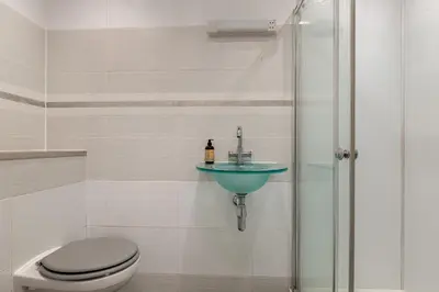 a bathroom with a toilet and a sink at Stylish Victorian Apartment's close to the Botanical gardens, Free parking! in Edinburgh