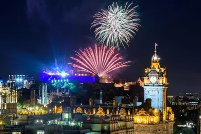 a fireworks display over a city with a clock tower at Stylish Victorian Apartment's close to the Botanical gardens, Free parking! in Edinburgh