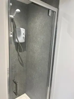 a shower with a shower head in a bathroom at Modern Comfy One Bed Apartment - Free Parking in Glasgow